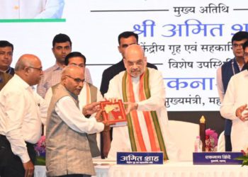 Shah presented with a copy of “Sahakar Maharshi”