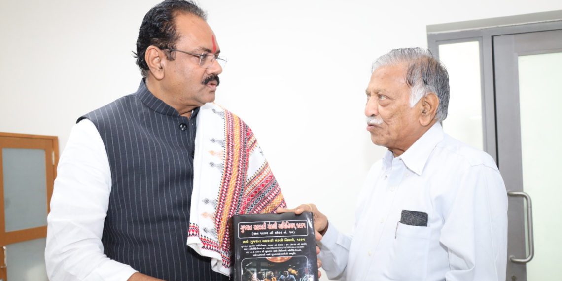 Amin presents book on Gujarat Co-op Law to Minister